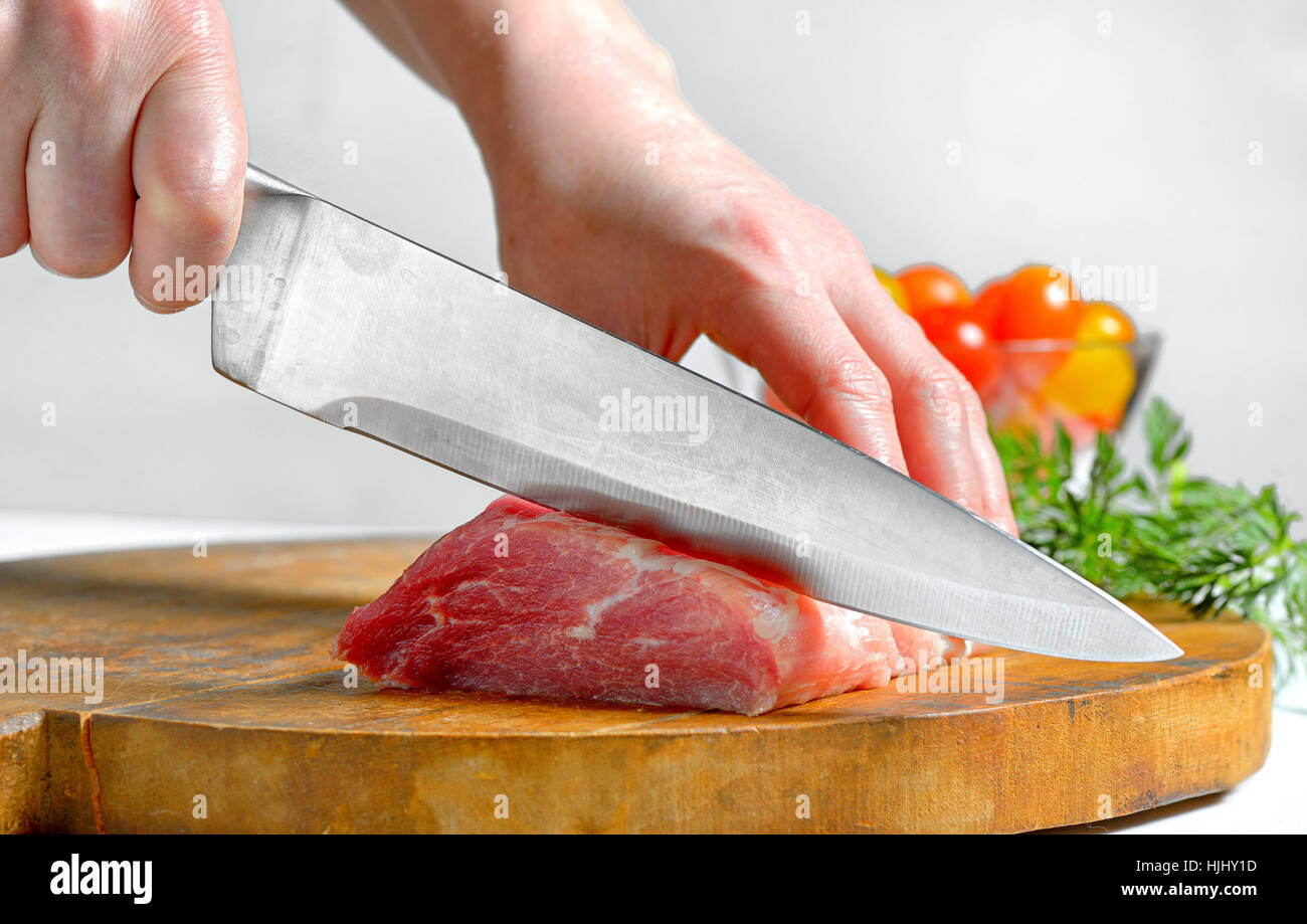 Stainless steel butcher knife cut meat Stock Photo