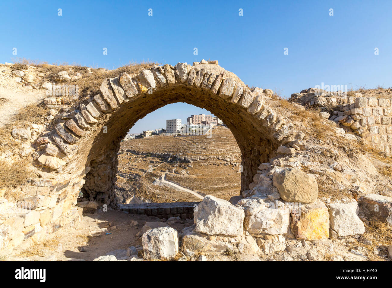 Jordan, Al-Karak, Kerak Crusader castle, view through archway on modern buildings Stock Photo