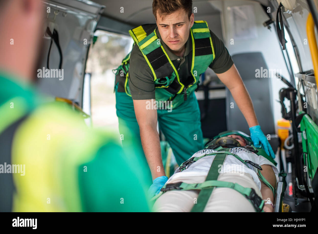 Paramedics moving car crash victim on stretcher Stock Photo - Alamy