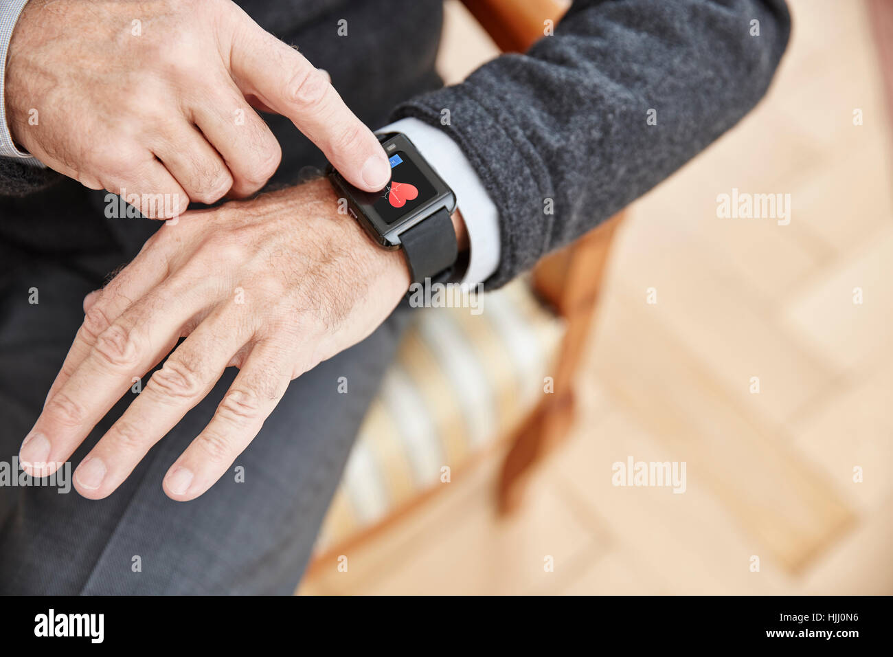 Senior man checking medical data on smartwatch Stock Photo