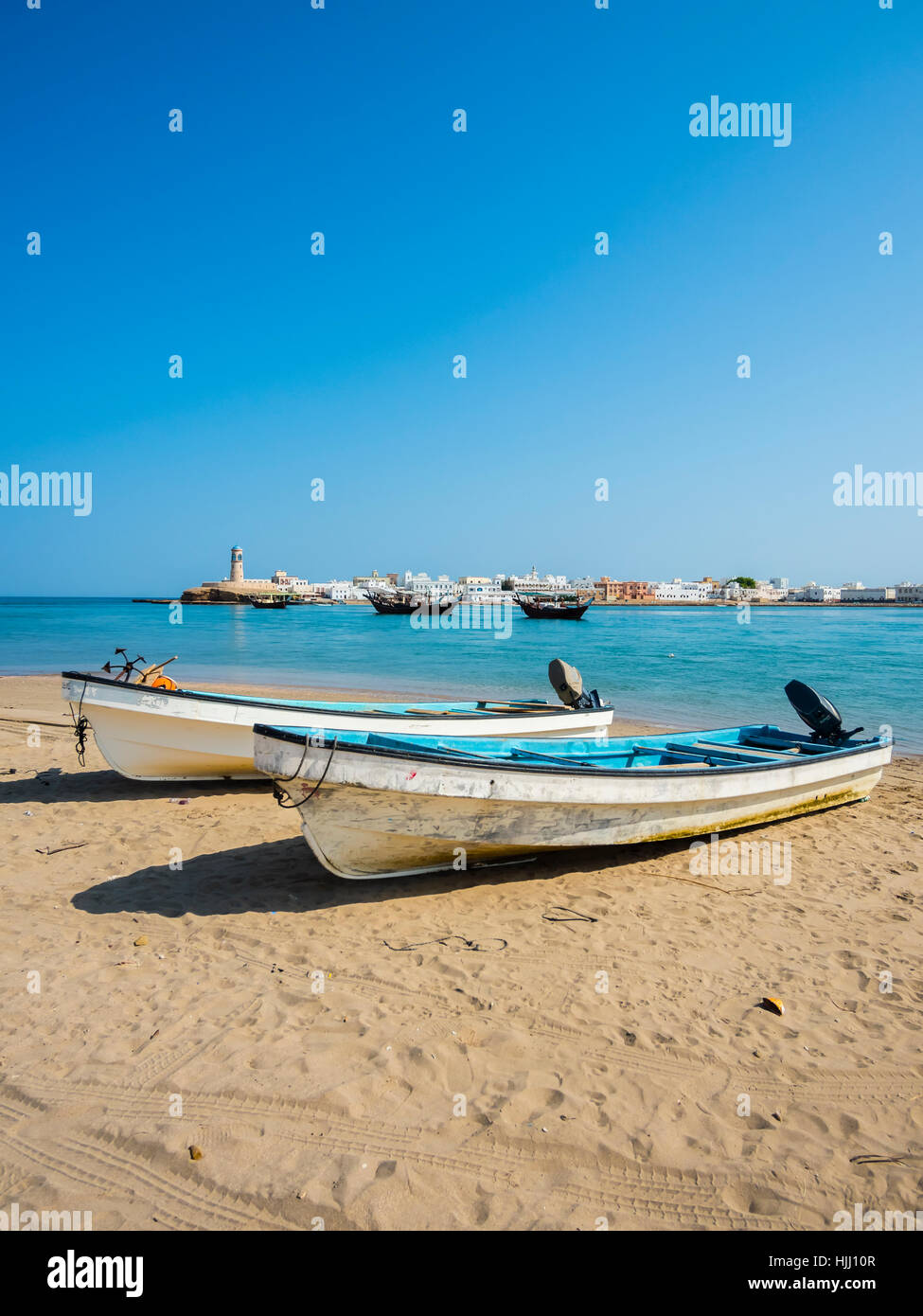 Oman, Ash Sharqiyah, Ad Daffah, two motorboats lying on beach of seaport Sur Stock Photo