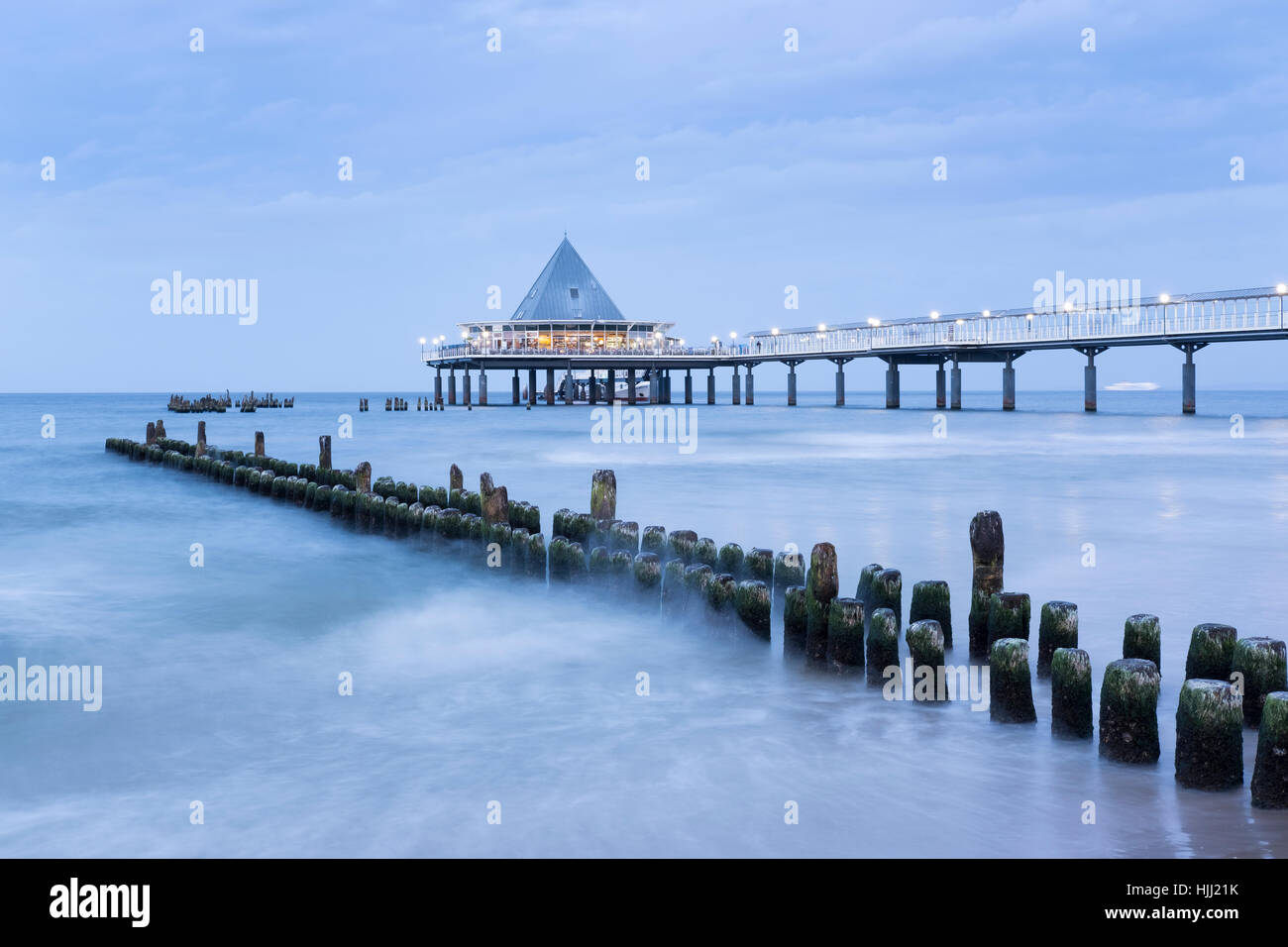 Germany, Usedom, Heringsdorf, remains of the old and new pier in the evening Stock Photo