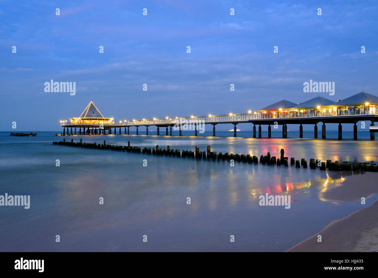 Germany, Usedom, Heringsdorf, remains of the old and new pier in the evening Stock Photo