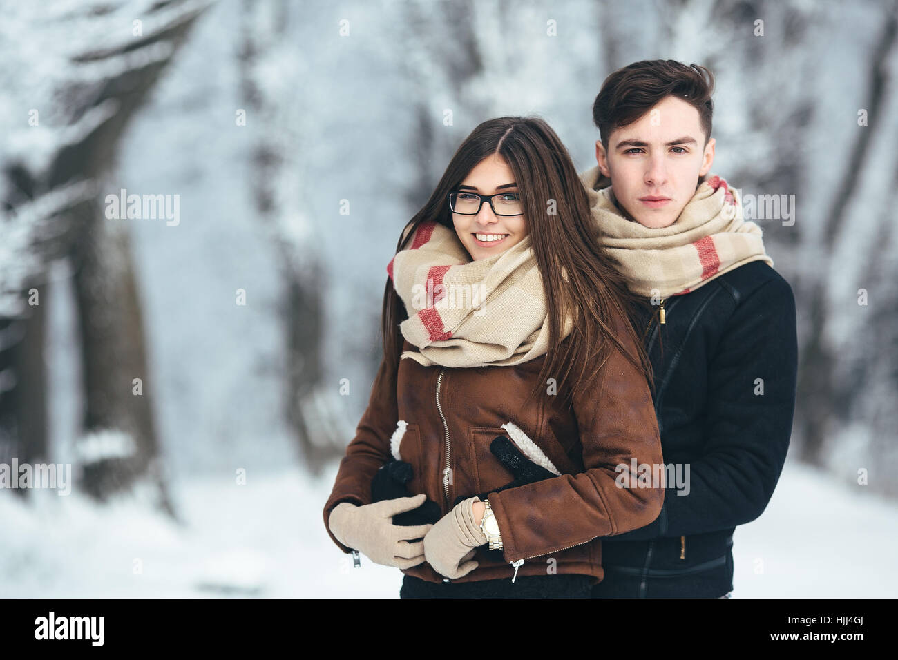 Happy couple in snow park Stock Photo - Alamy