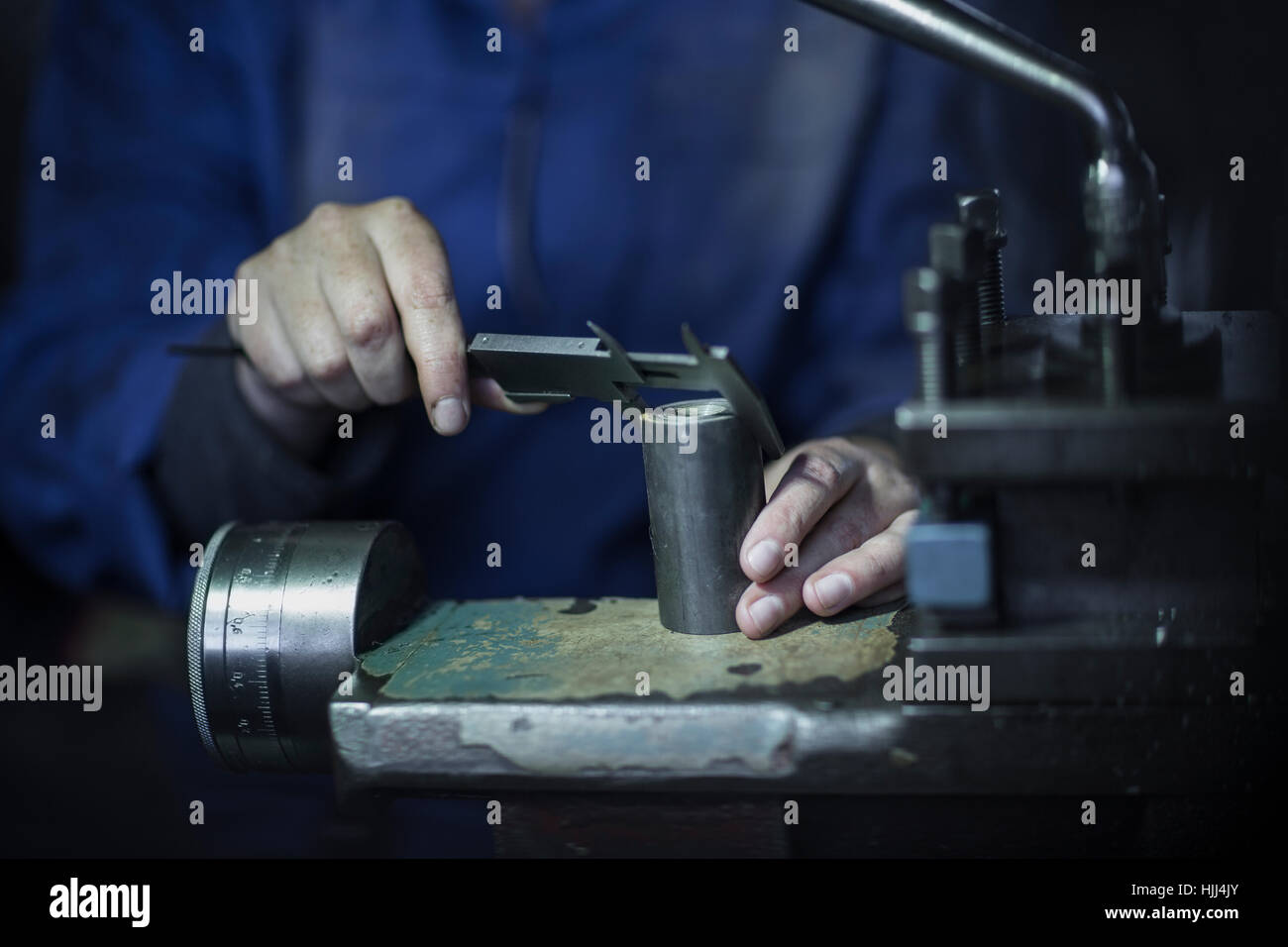 Woman using Vernier caliper in to measure diameter Stock Photo