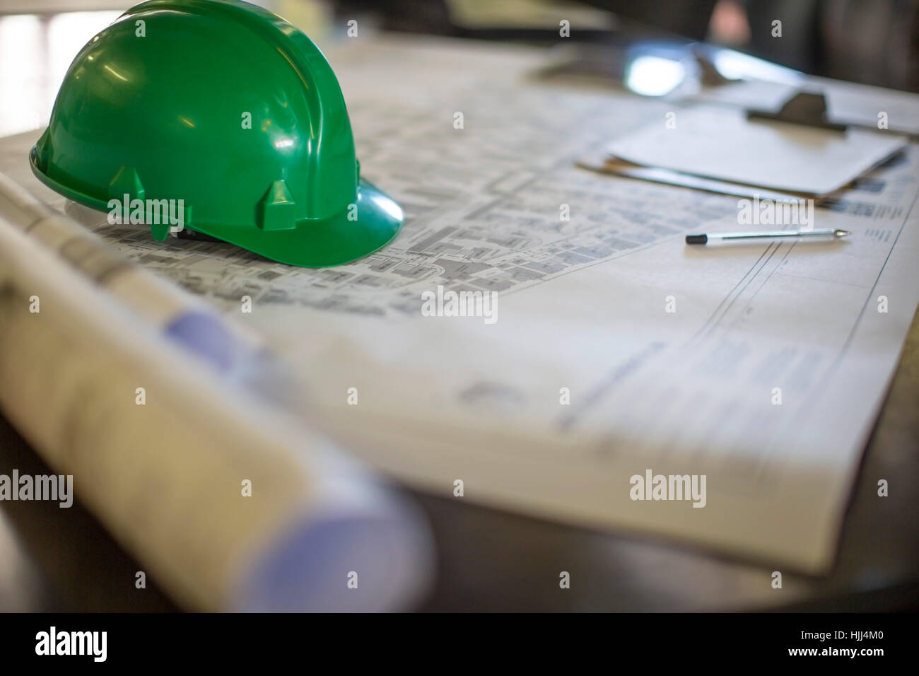 Construction helmet on blueprints in site office Stock Photo - Alamy