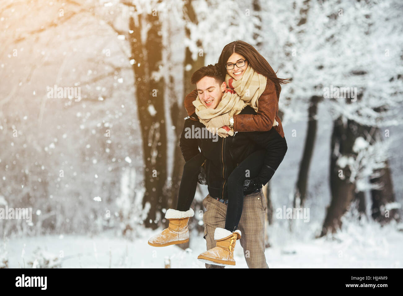 Happy couple playful together in snow park Stock Photo - Alamy