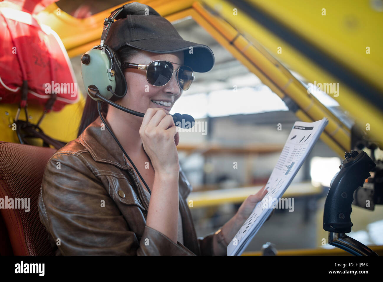 Female pilot inspecting light aircraft cockpit Stock Photo