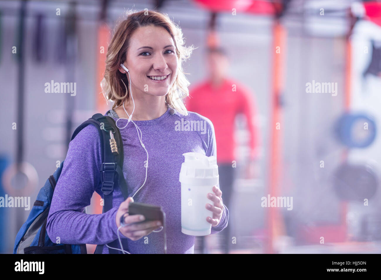 Portrait of smiling young woman in gym Stock Photo - Alamy