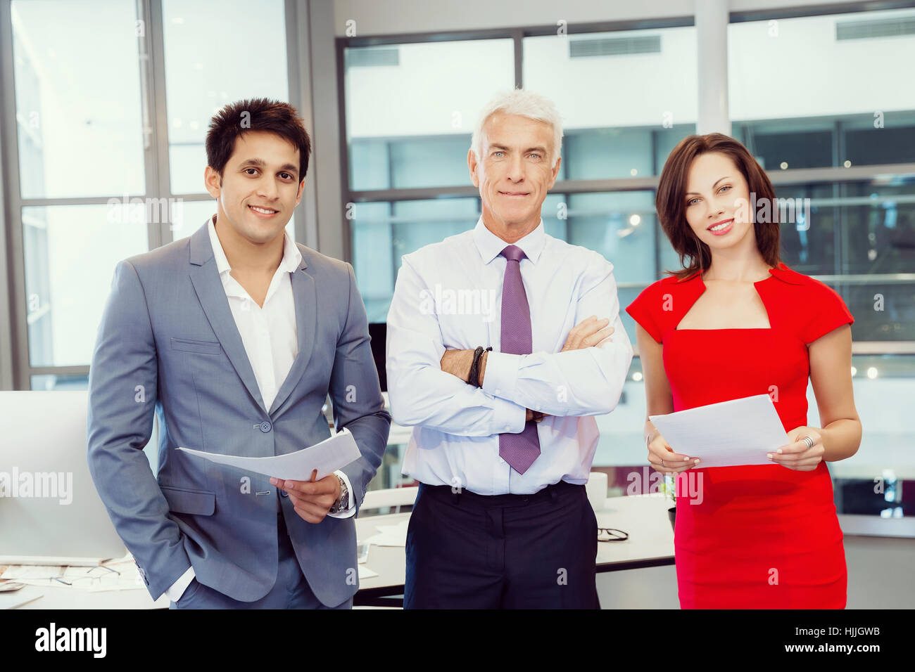 Group of businesspeople in office standing Stock Photo - Alamy