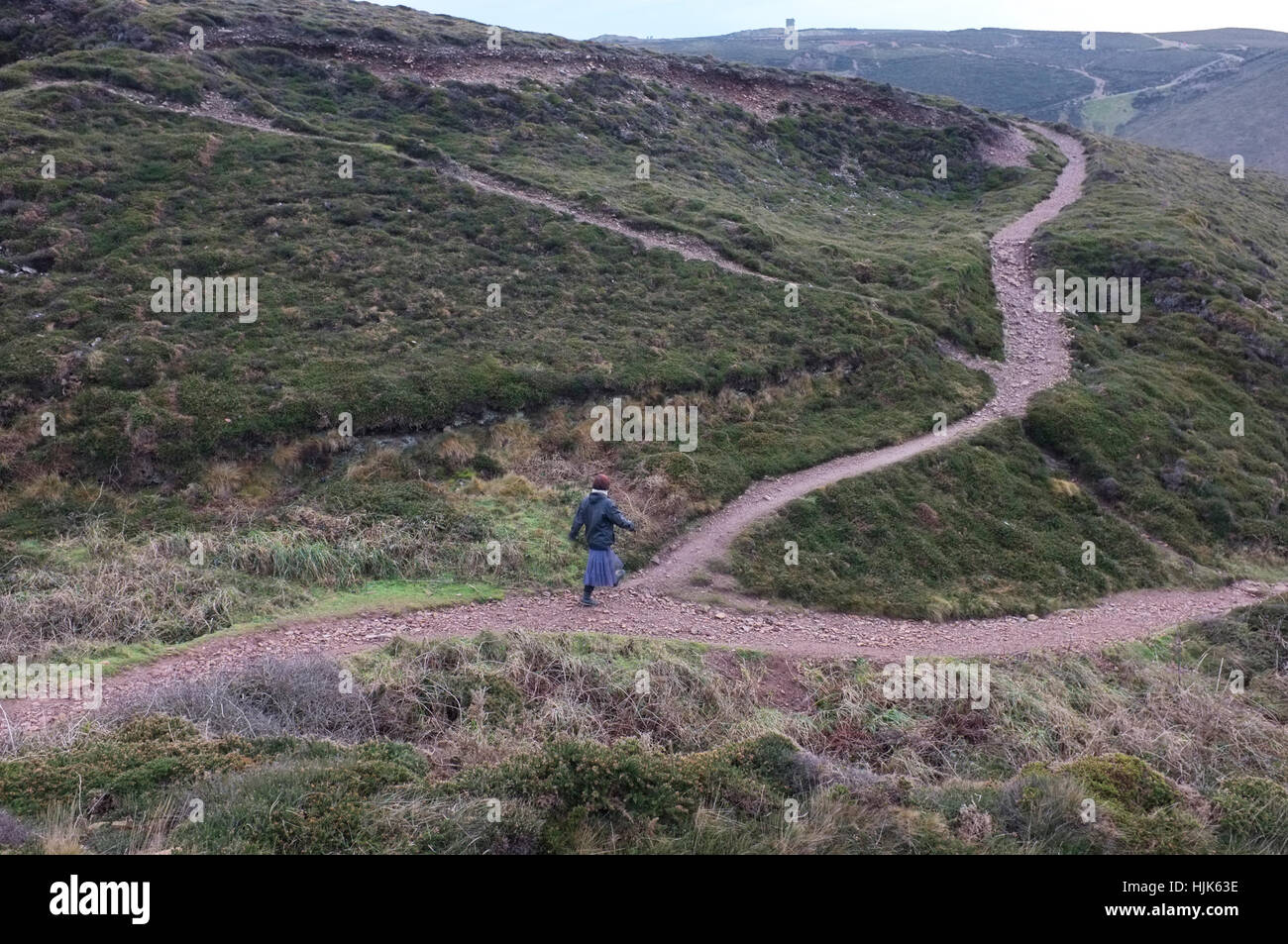 A woman chooses between two paths Stock Photo