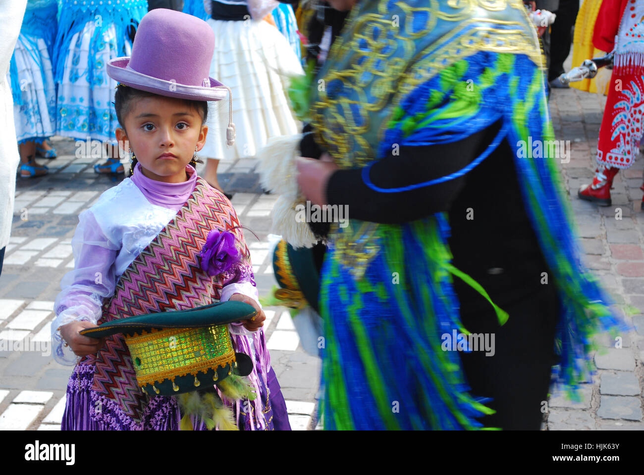 A little girl dressed up in traditional costumer ready to perform in the religious festival, Plaza de Armas, Cusco, Peru Stock Photo