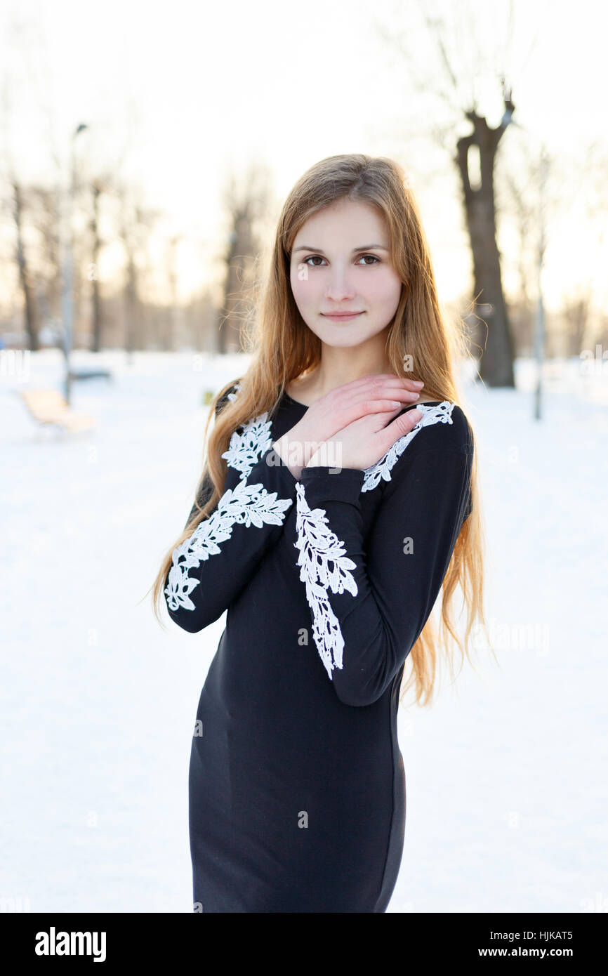 Young girl with long hair in black dress Stock Photo - Alamy
