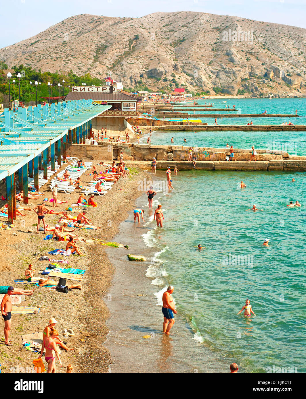 People at a sea beach in Sudak. Crimea, Russian Federation Stock Photo