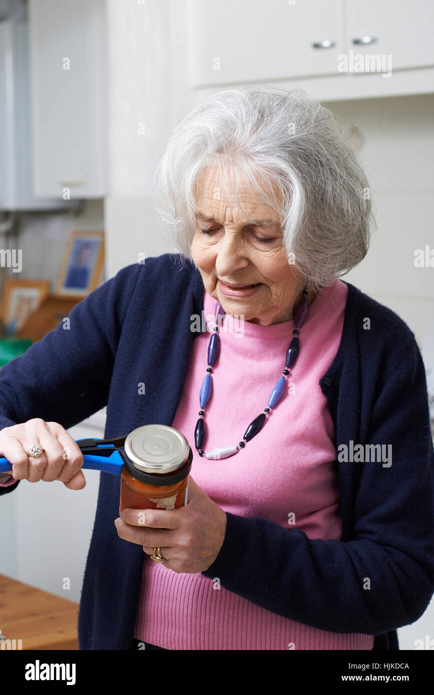 Senior Woman Taking Lid Off Jar With Kitchen Aid Stock Photo Alamy
