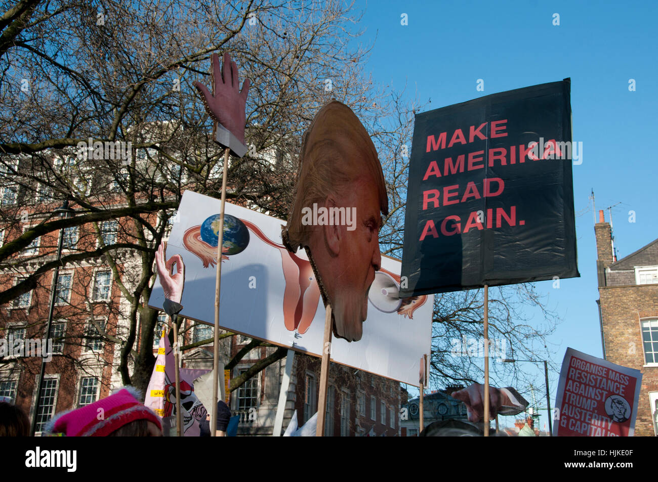 Women's anti-Trump march, London.Trump's head on a stick, his hands and a placard showing a woman's reproductive organs Stock Photo