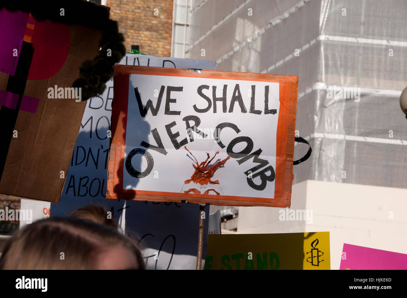 Women's anti-Trump march, London.Placard saying 'We shall overcomb'. Stock Photo