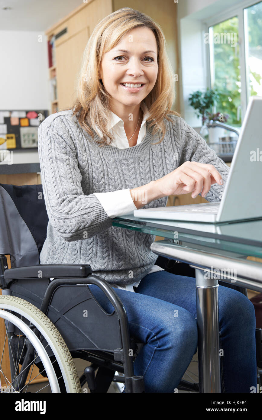 Disabled Woman In Wheelchair Using Laptop At Home Stock Photo - Alamy