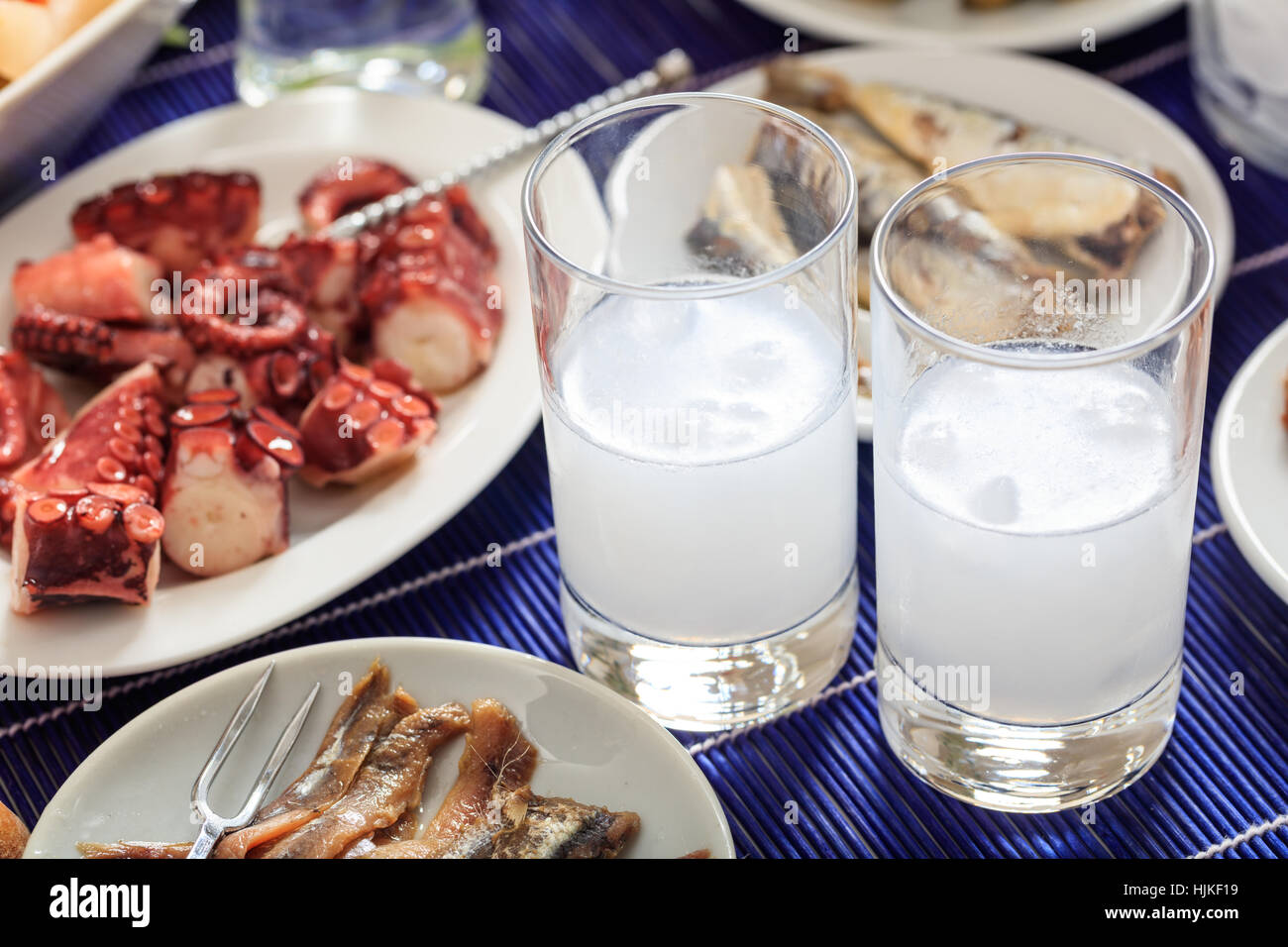 Glasses of ouzo and appetizers Stock Photo