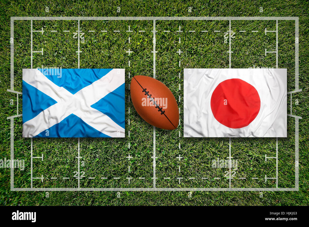 Scotland vs. Japan flags on green rugby field Stock Photo