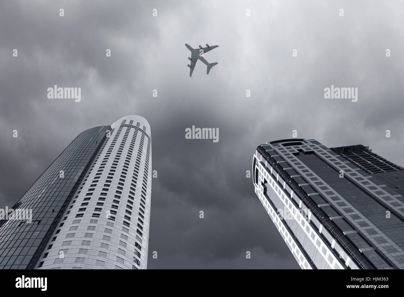 Bottom view of airplane flying above skyscrapers Stock Photo - Alamy