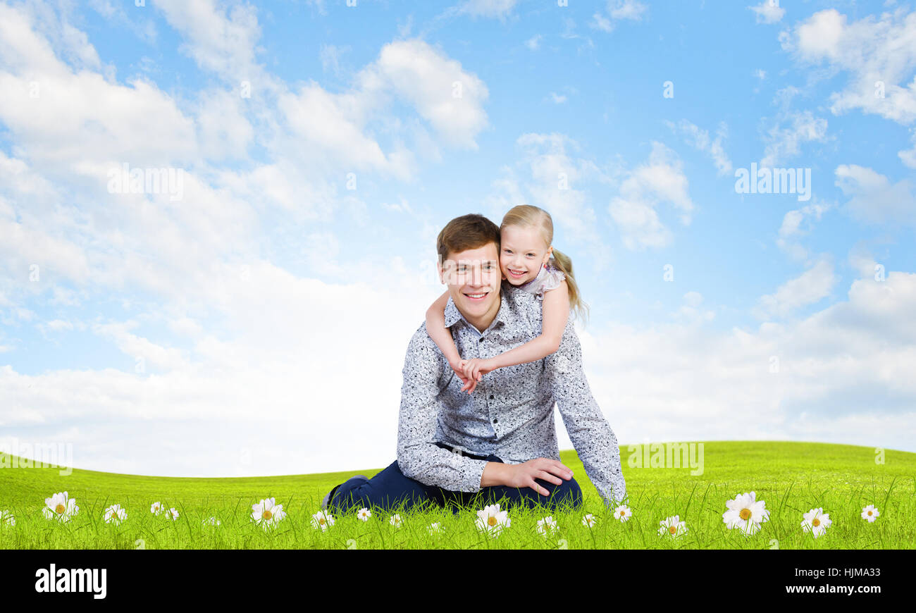 Happy family of father and daughter sitting on grass Stock Photo - Alamy