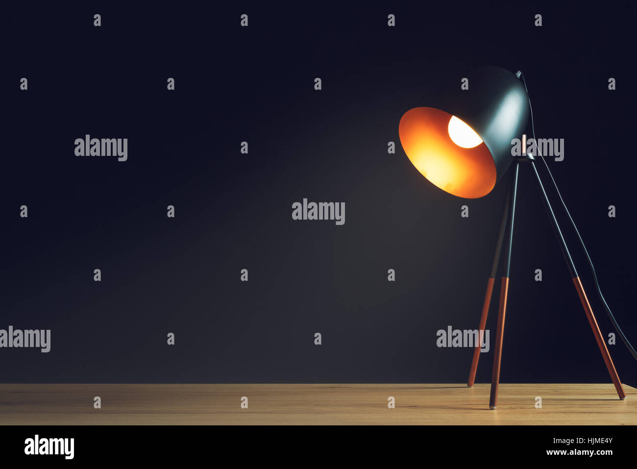 Desk lamp on empty wooden office table as space for text or product placement Stock Photo