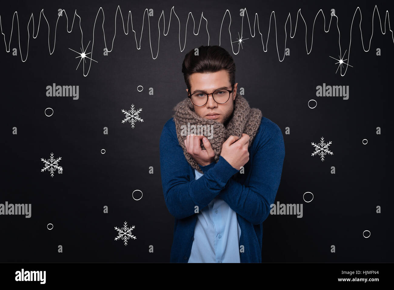 Handsome young man shivering in cold weather. Stock Photo