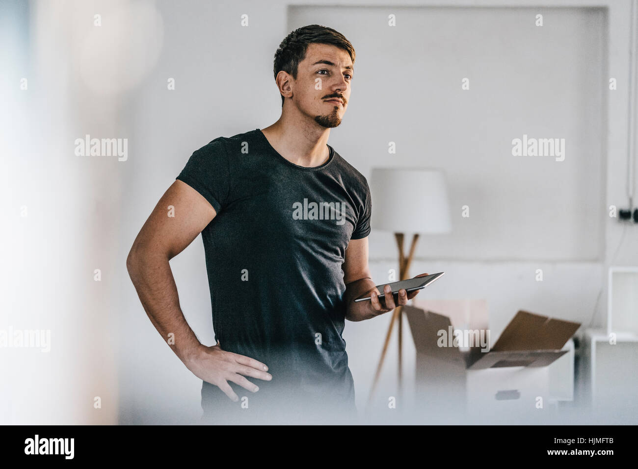 Black man thinking tablet hi-res stock photography and images - Alamy