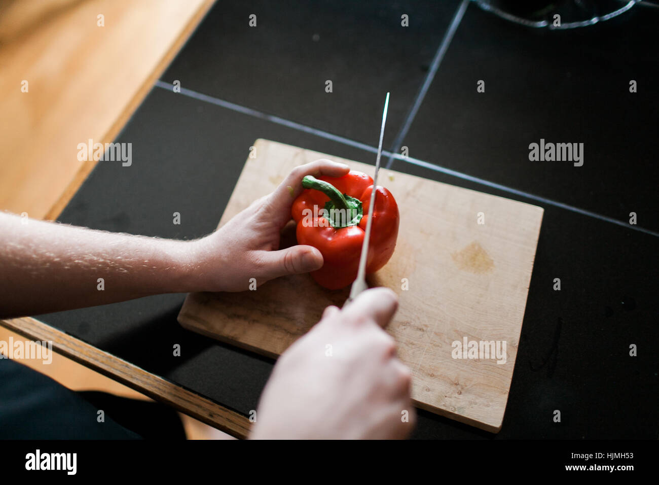 Slicing a red bell pepper on a cutting board Stock Photo - Alamy