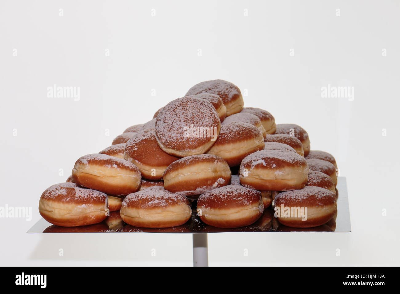 Heap of Fried Bavarian Cream Filled Donuts on Tray Stock Photo
