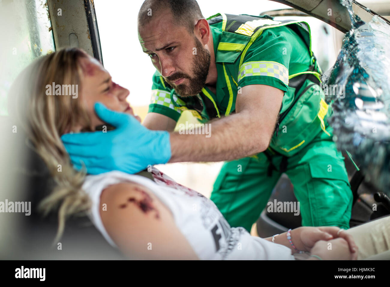 Paramedic helping car crash victim after accident Stock Photo Alamy