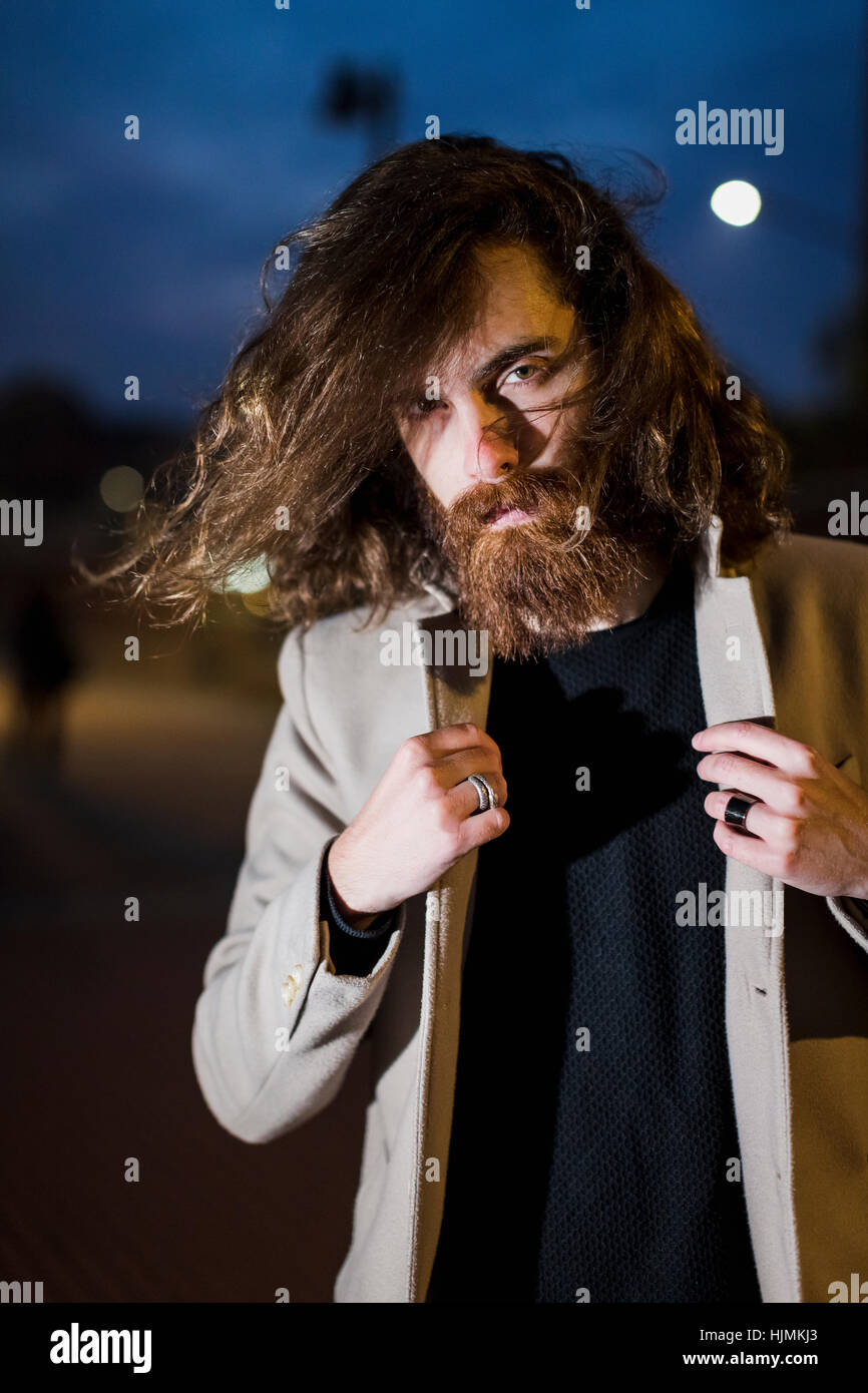 Portrait of stylish young man outdoors in the city at night Stock Photo ...