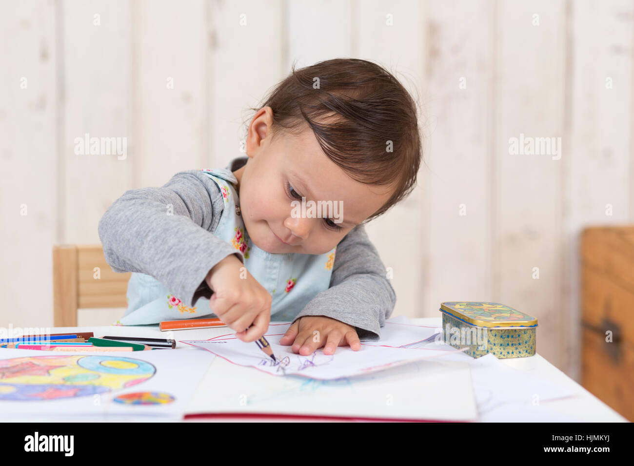 Little girl drawing with coloured pencil Stock Photo - Alamy