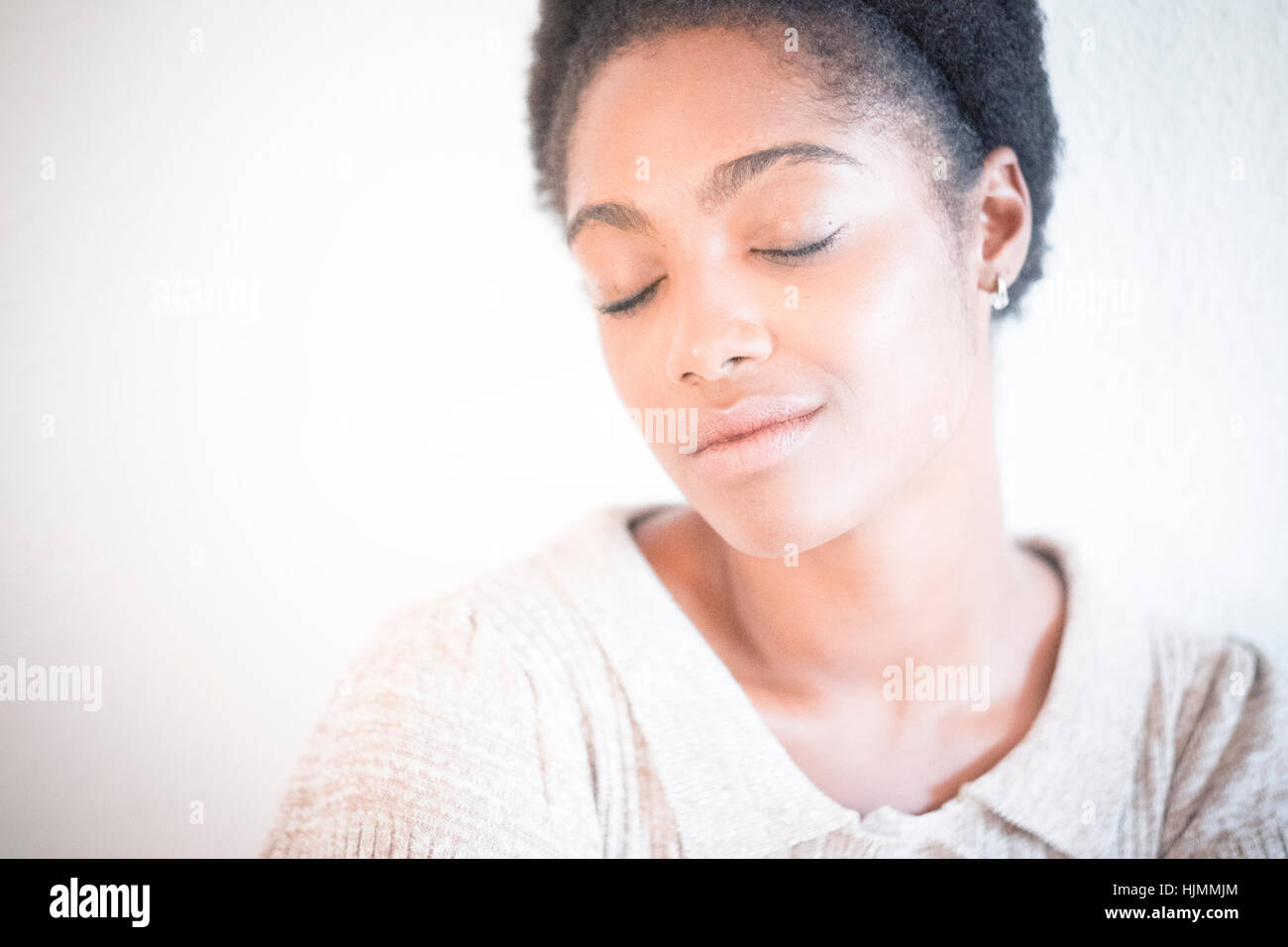 Portrait of young woman with eyes closed Stock Photo - Alamy