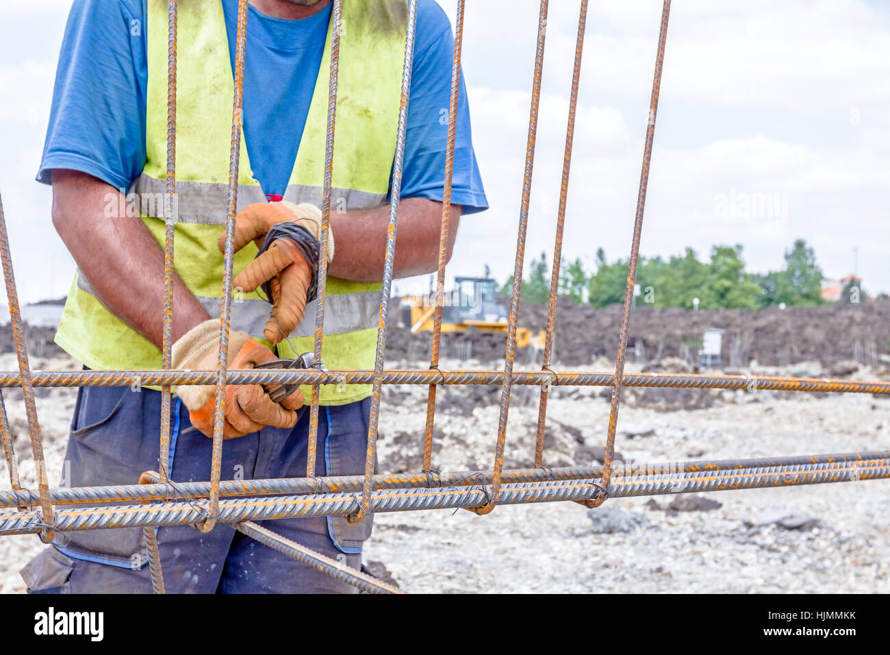 Worker is tying rebar to make a newly constructed footing frame. Binding concrete frame Stock