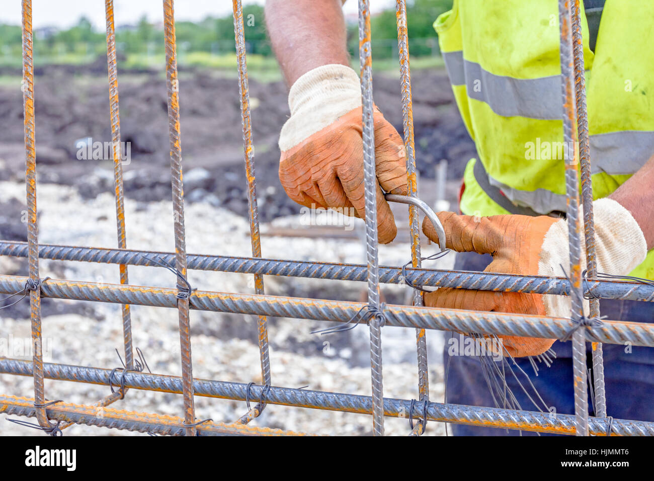 Worker is tying rebar to make a newly constructed footing frame. Binding concrete frame Stock