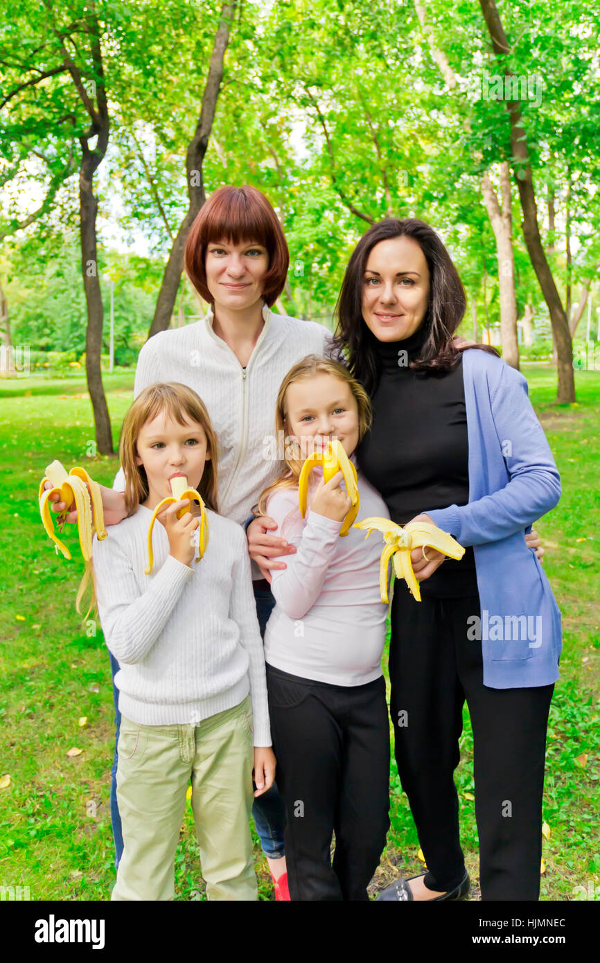 Photo of group people are eating bananas Stock Photo