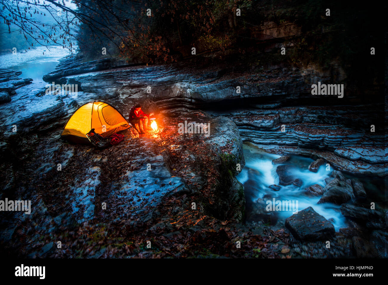 Austria, Salzburg State, Tennengau, senior man camping at Taugl brook Stock Photo