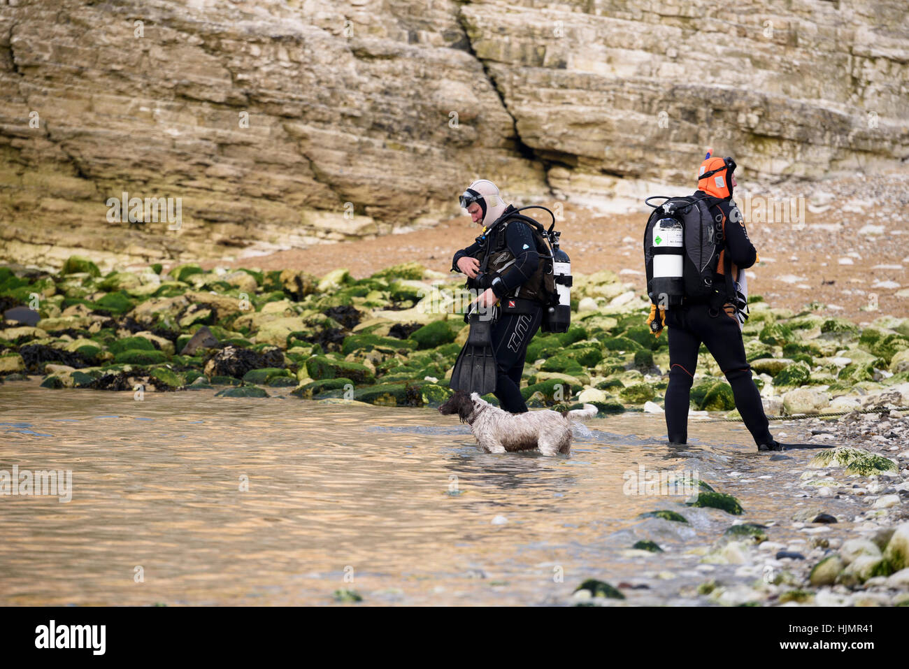 Scuba diving is a popular leisure activity and here, 3 male divers are preparing to go into the sea - North Landing, Flamborough, East Yorkshire, GB. Stock Photo