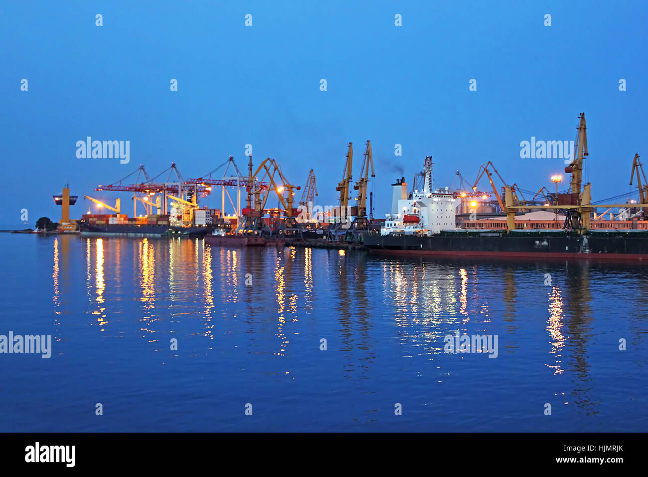 Seaport at night with light reflections on sea water Stock Photo
