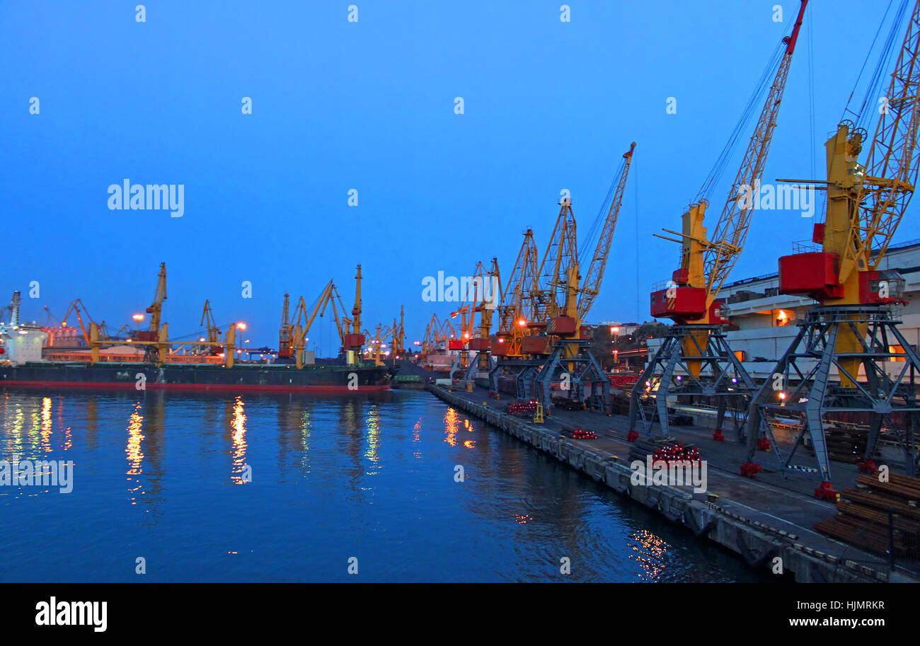 Seaport at night with light reflections on sea water Stock Photo