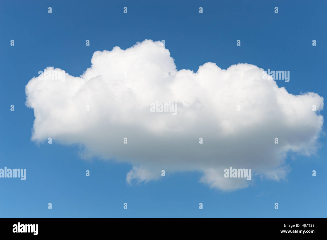 One single fluffy Cumulus cloud in clear deep blue summer sky Stock Photo