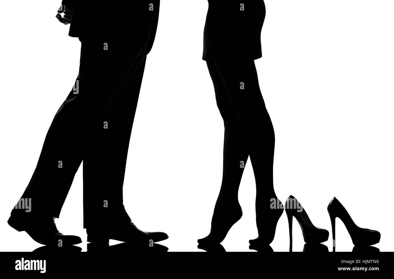 one caucasian detail legs feet couple man and woman tiptoe lovers teenderness in studio silhouette isolated on white background Stock Photo
