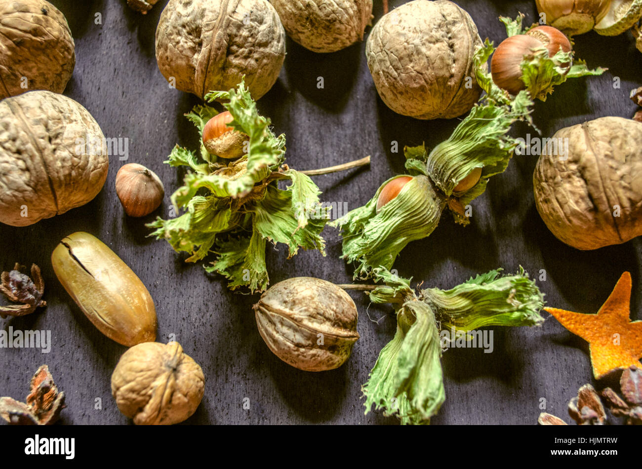 Nuts,hazelnuts with dry peduncle,acorns on black background Stock Photo
