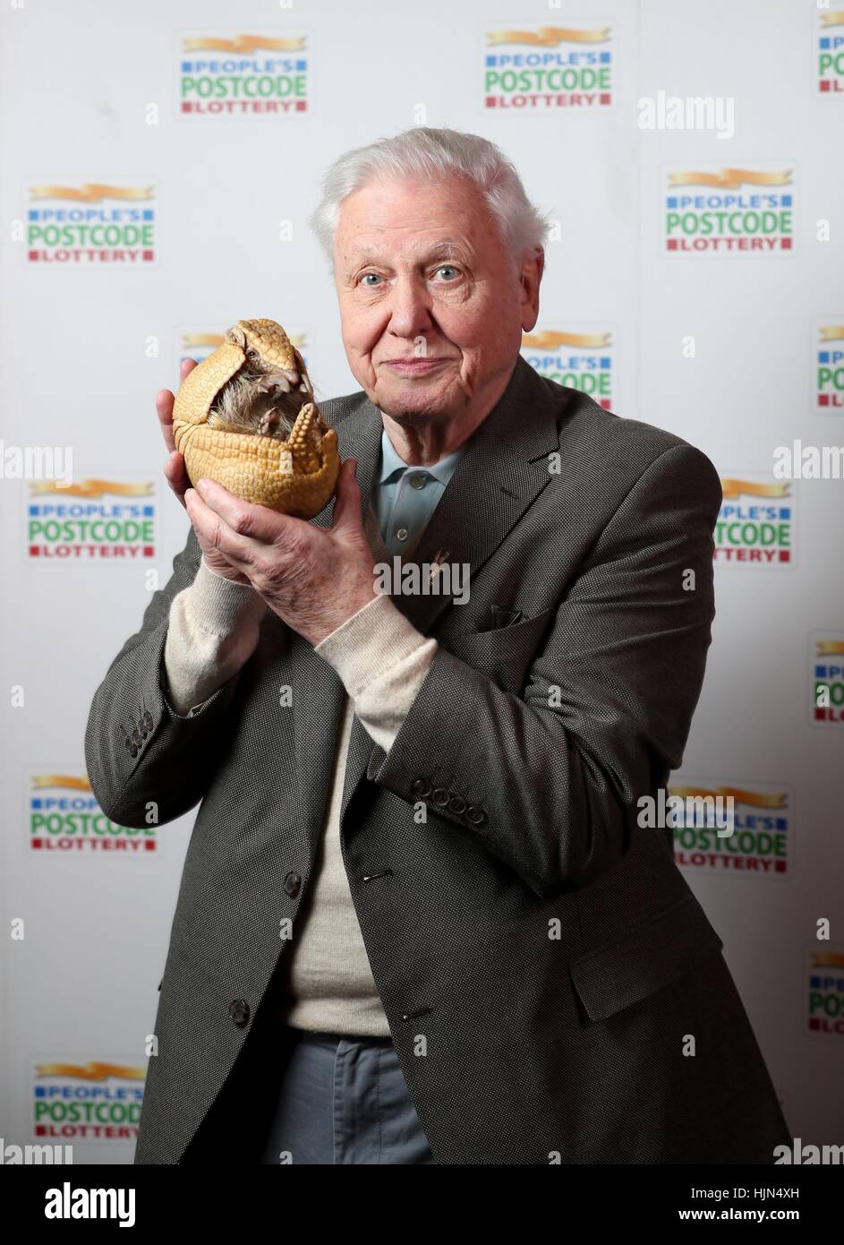 Sir David Attenborough holds 'Inti', an armadillo from Edinburgh Zoo, before receiveing a &Acirc;&pound;250,000 cheque from the People's Postcode Lottery for the charity Fauna & Flora International of which he is Vice-President, at Prestonfield House, Edinburgh. Stock Photo