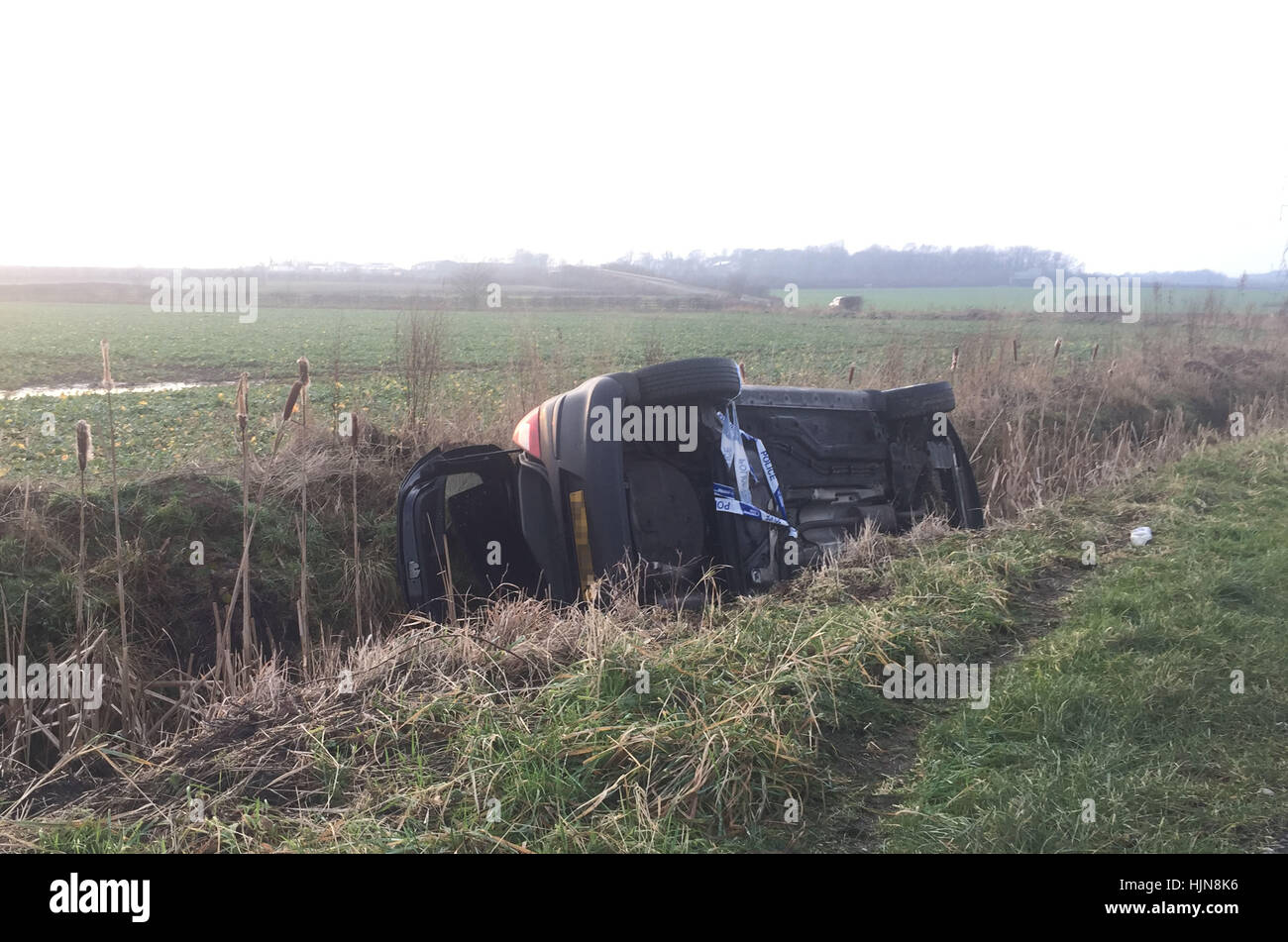 NUMBERPLATE PIXELATED BY PA PICTURE DESK A car on its side in a ditch ...
