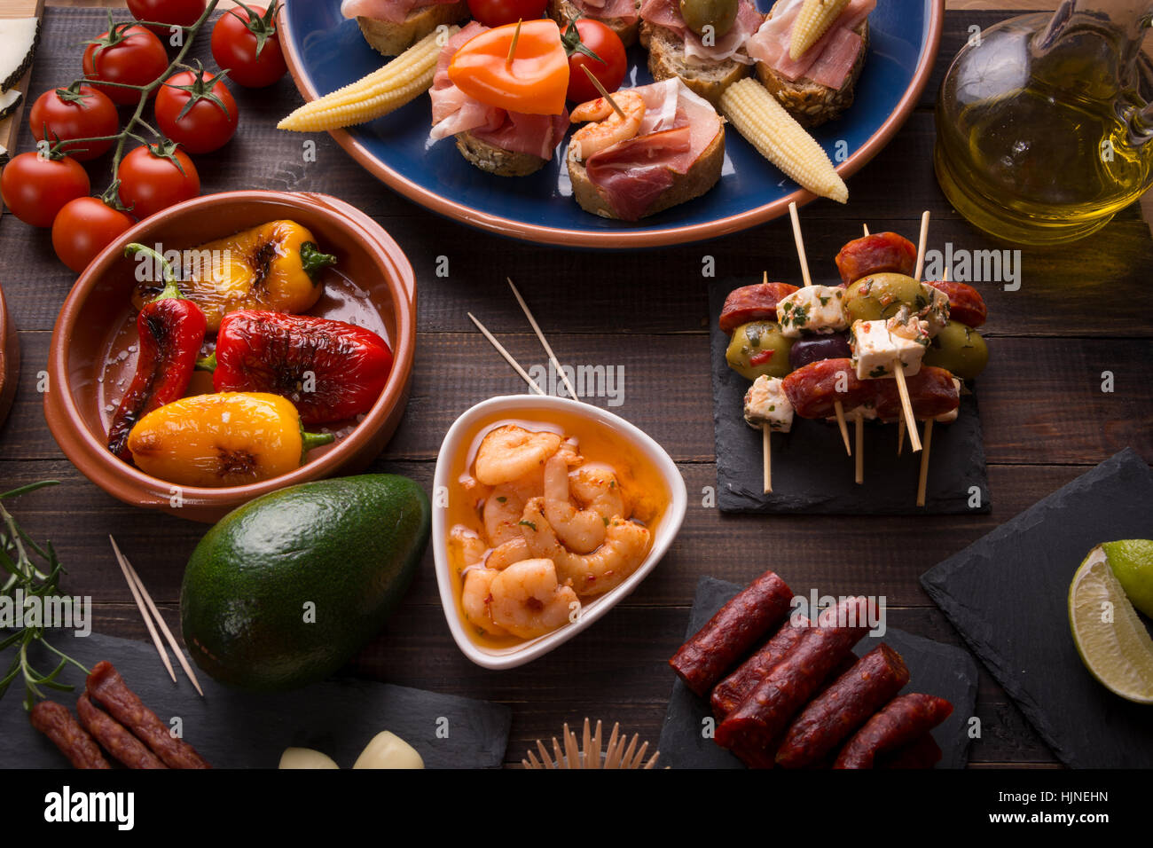 Top view of variety of mediterranean starters spanish tapas with chorizo, prawns and olives