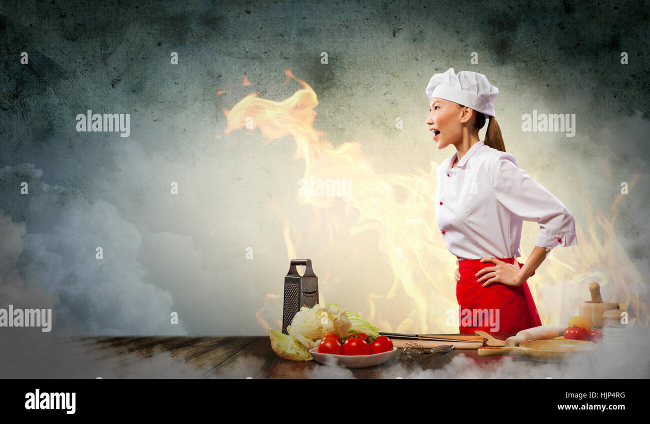 Asian female cook in anger against color background with shine effects ...