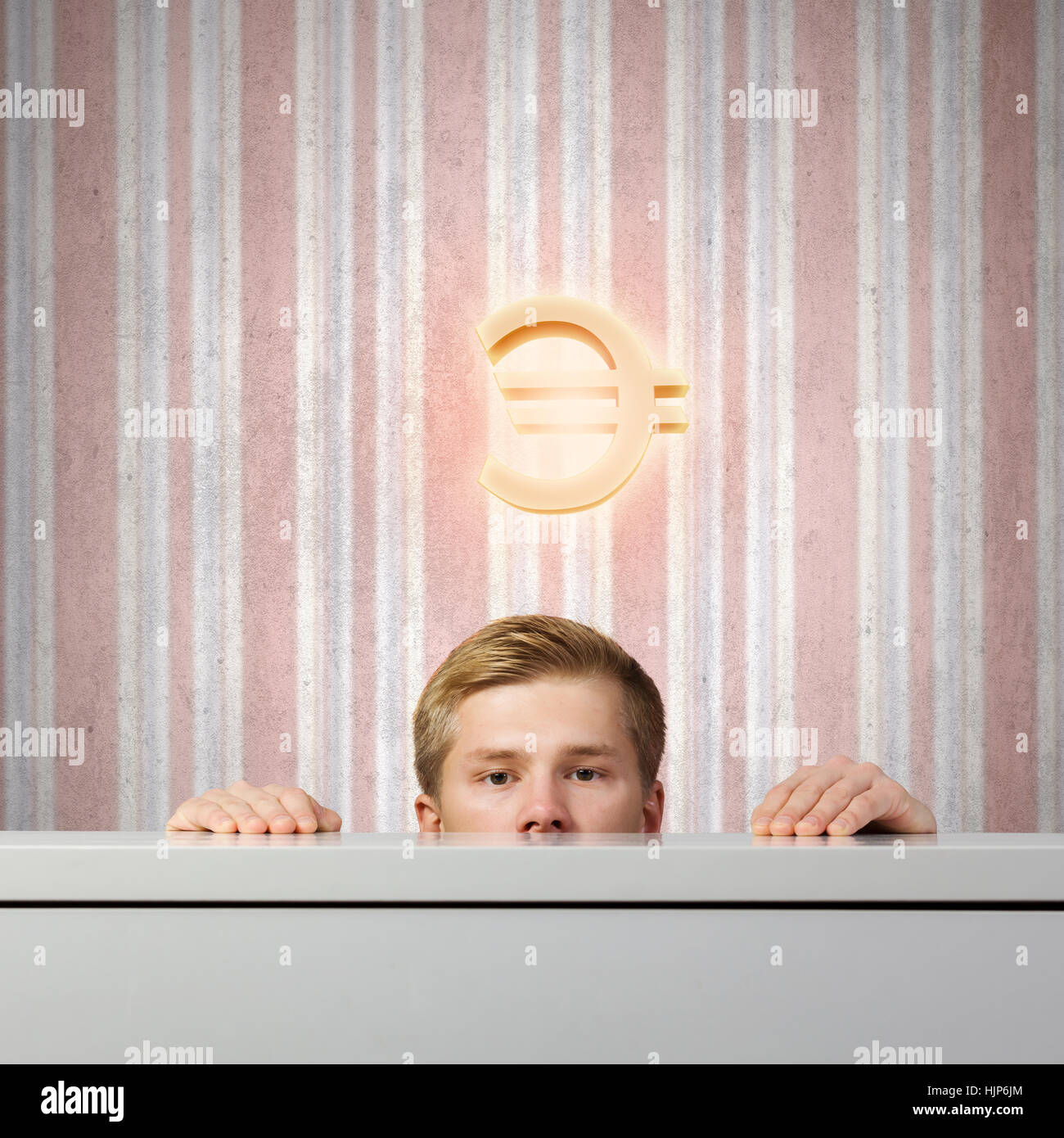 Half of face of young man looking out from under table Stock Photo - Alamy